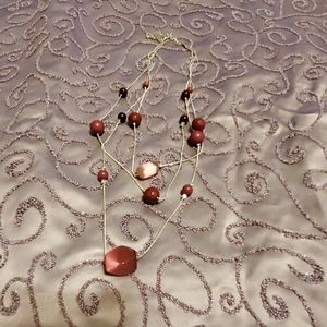 Very classy silver necklace with burgundy beads.